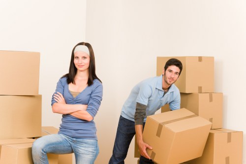 Removal team handling boxes and furniture in a Lambeth flat