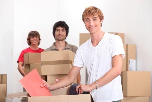 Local moving team packing boxes for a flat move in Lambeth